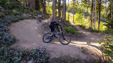 Deer Valley Mountain Bike Instructor biking with student.