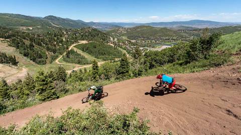 Mountain biker following Deer Valley bike instructor.