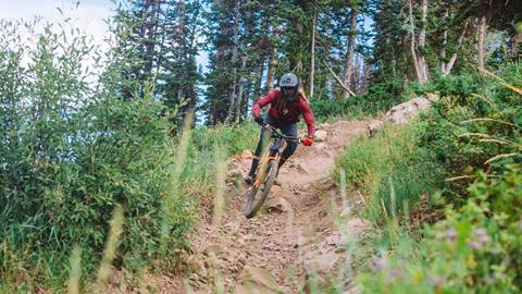 Man mountain biking on a flow trail at Deer Valley.