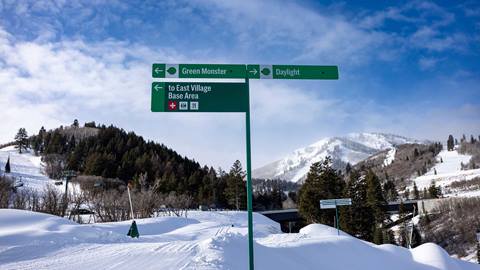 Green Monster and Daylight trail signs at Deer Valley East Village.