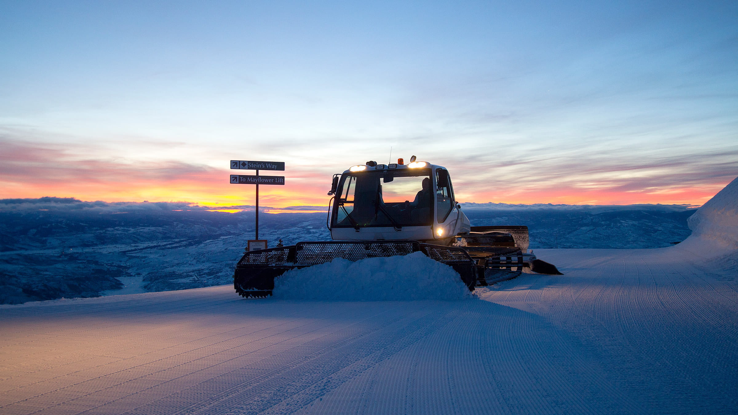 Snow cat grooming mountain
