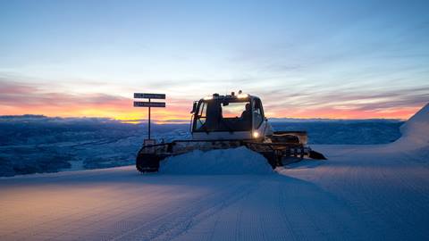 Snow cat grooming mountain