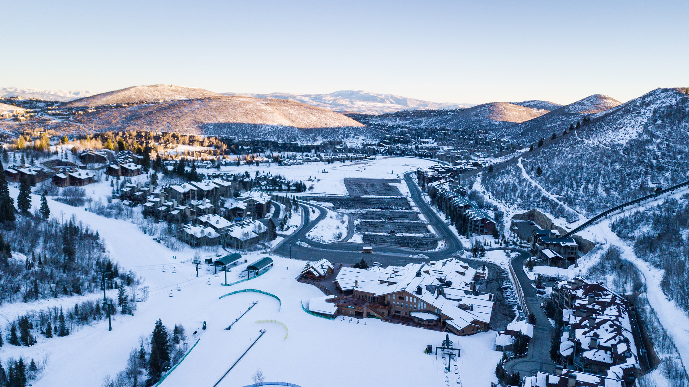 Drone image of Snow Park Lodge and parking lots during the winter season.