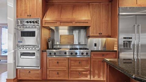 Luxury Deer Valley mountain home kitchen with custom wood cabinetry and stainless steel appliances at 7780 Sterling Drive