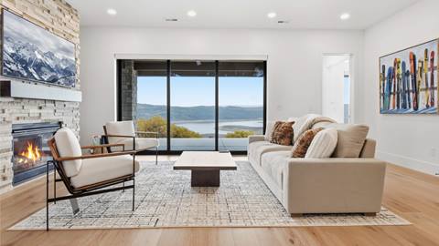 Family room with a fireplace and lake views inside Deer Valley's luxury lodging property, Amanti Lago 11346.