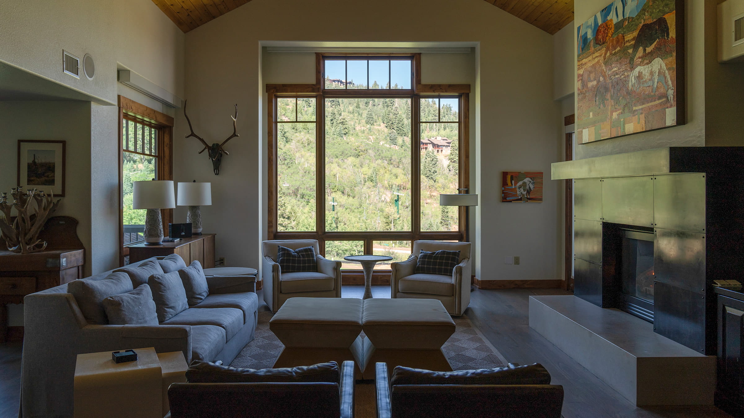 Common area couches in front of large window at the Black Diamond Lodge.