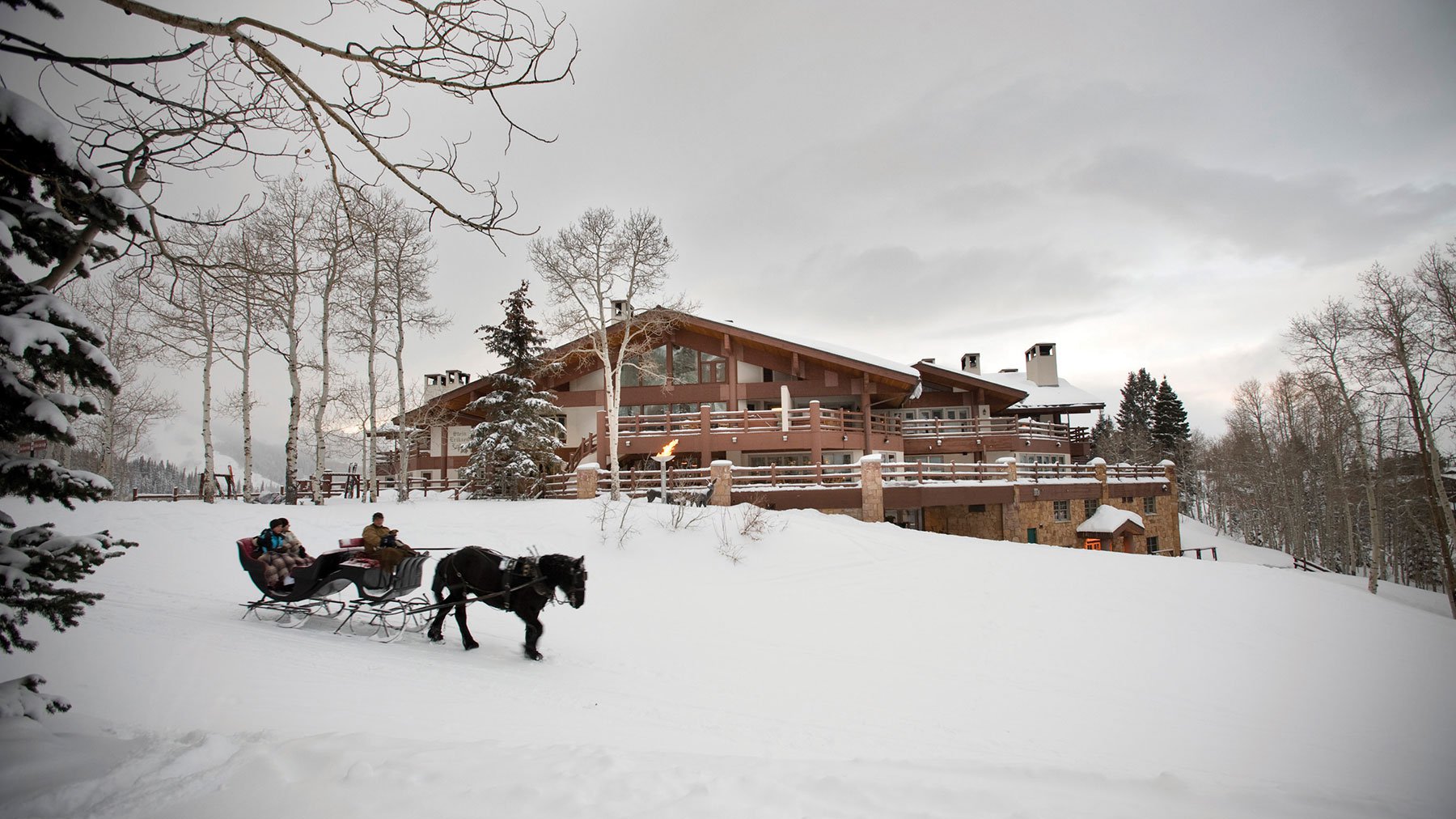 Winter Exterior of Stein Eriksen Lodge with horse drawn sleigh
