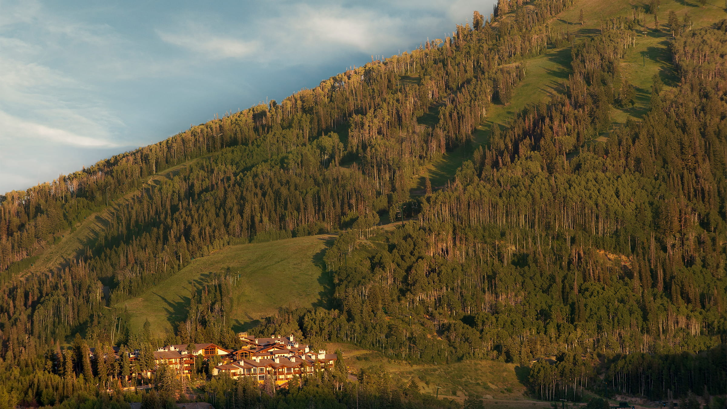 Stein Eriksen Lodge summer exterior with Bald Mountain in the background