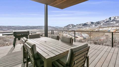 Private deck at SkyRidge 1307 with mountain views, outdoor dining, and grill.