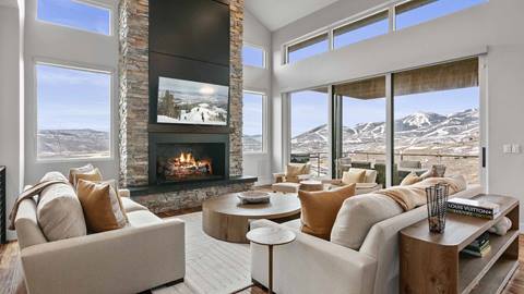 Living room in SkyRidge 1307 with fireplace and panoramic mountain views.
