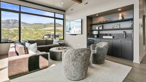 SkyRidge 1585 entertainment room with sofa, chairs, bar, and television