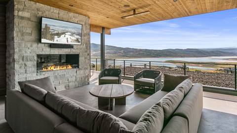 SkyRidge 1585 outdoor patio featuring sofa, chairs, TV, and fireplace