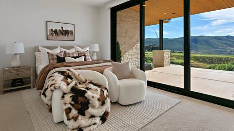 Bedroom with patio access and mountain views inside Deer Valley's luxury lodging property, SkyRidge 1643.