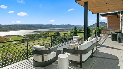 Expansive deck with lake and golf course views at Deer Valley's luxury lodging property, SkyRidge 1643, in the summer.