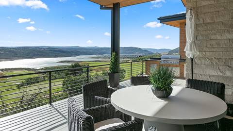 Outdoor dining table with lake and mountain views at Deer Valley's luxury lodging property, SkyRidge 1643.