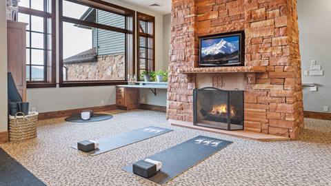 Yoga mats in Stag Lodge's fitness center, offering a calming space for practice.