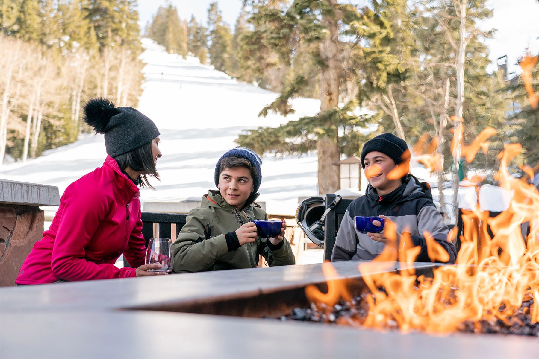 Family sitting by firepit at Deer Valley rental property.