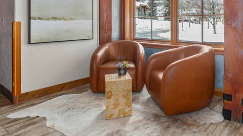 Two comfortable chairs near a window on the first floor of the lobby at Lodges at Deer Valley. 