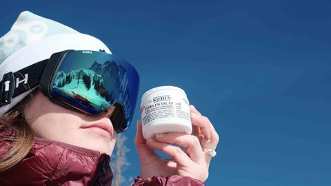 Skier holding Kiehl's product.