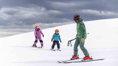 Deer Valley Ski Instructor watching two young kids ski in Park City, Utah.