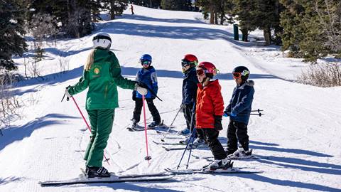 Deer Valley Ski Instructor teaching group kids ski lesson.