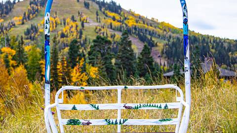 Artistic representation by Lamont Joseph White of two skiers and wild animals on Burns Chair Number 7.