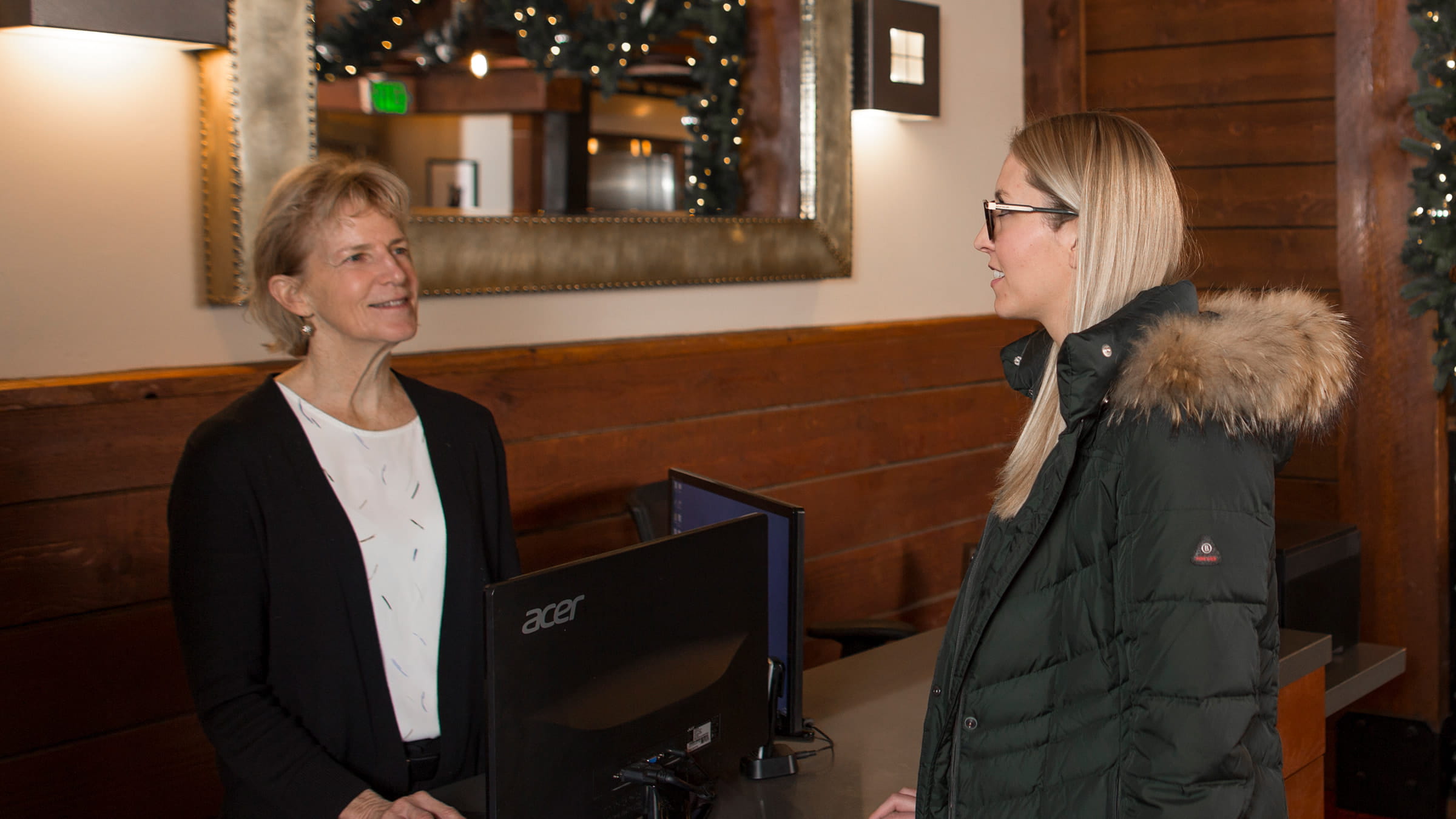 A guest is talking with the lodging property front desk staff