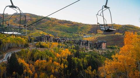 Two chairlifts surrounded by foliage at Deer Valley Resort in Park City, UT.
