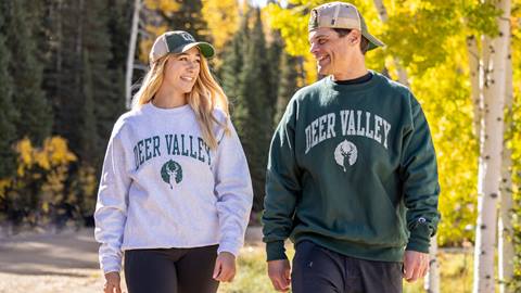 Couple going on a walk wearing Deer Valley sweat shirts.