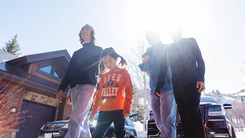 Group of kids wearing Deer Valley apparel walking together.