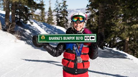 Shannon Bahrke holding custom trail sign at Deer Valley
