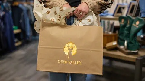 Woman holding Deer Valley gift bag.