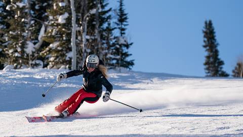 Skier carving on a bluebird day
