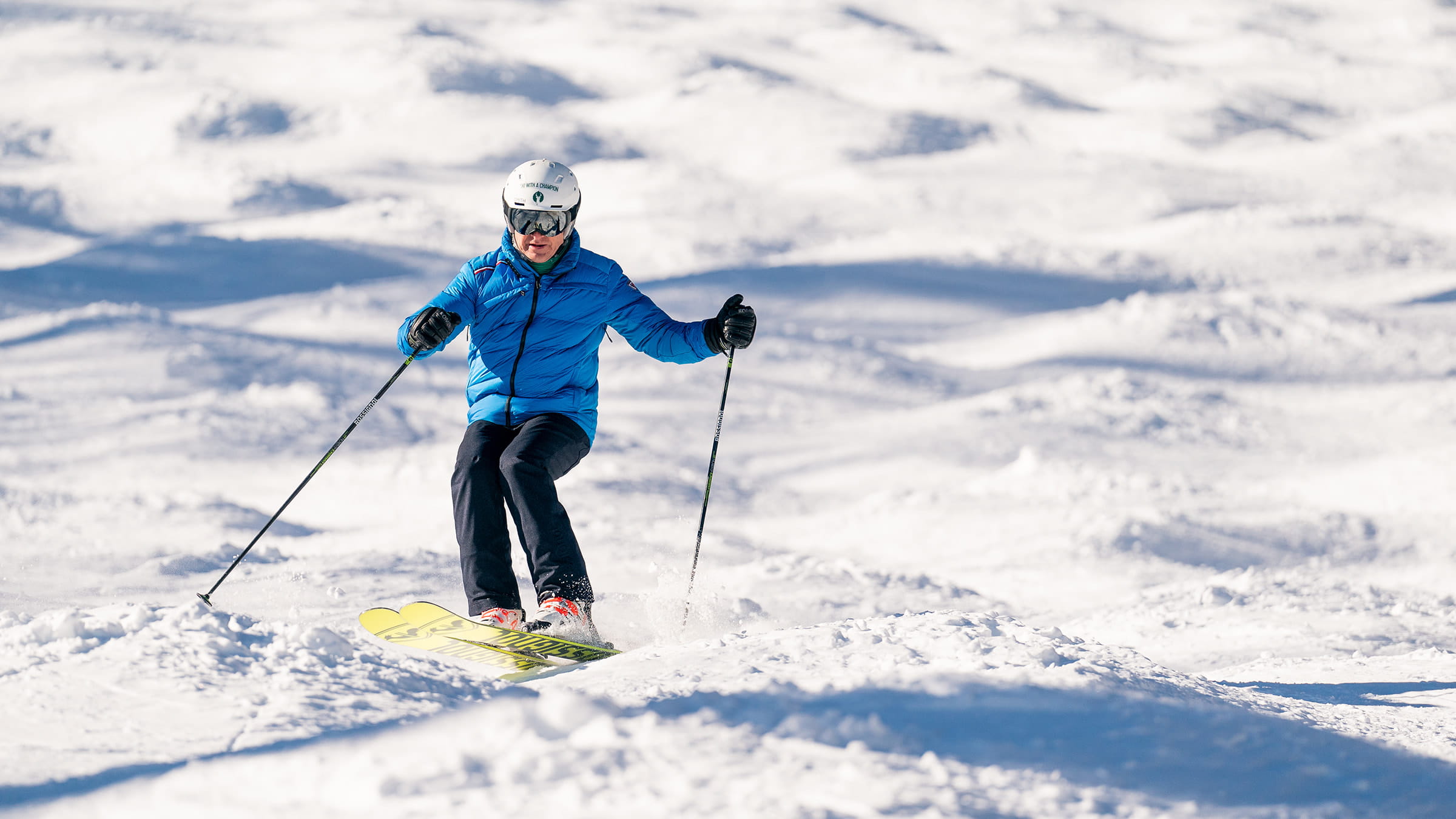Skier skiing moguls.