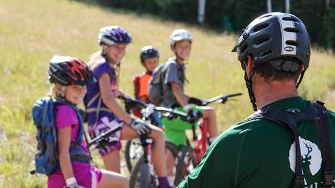 Deer Valley mountain bike coach teaching group of kids.