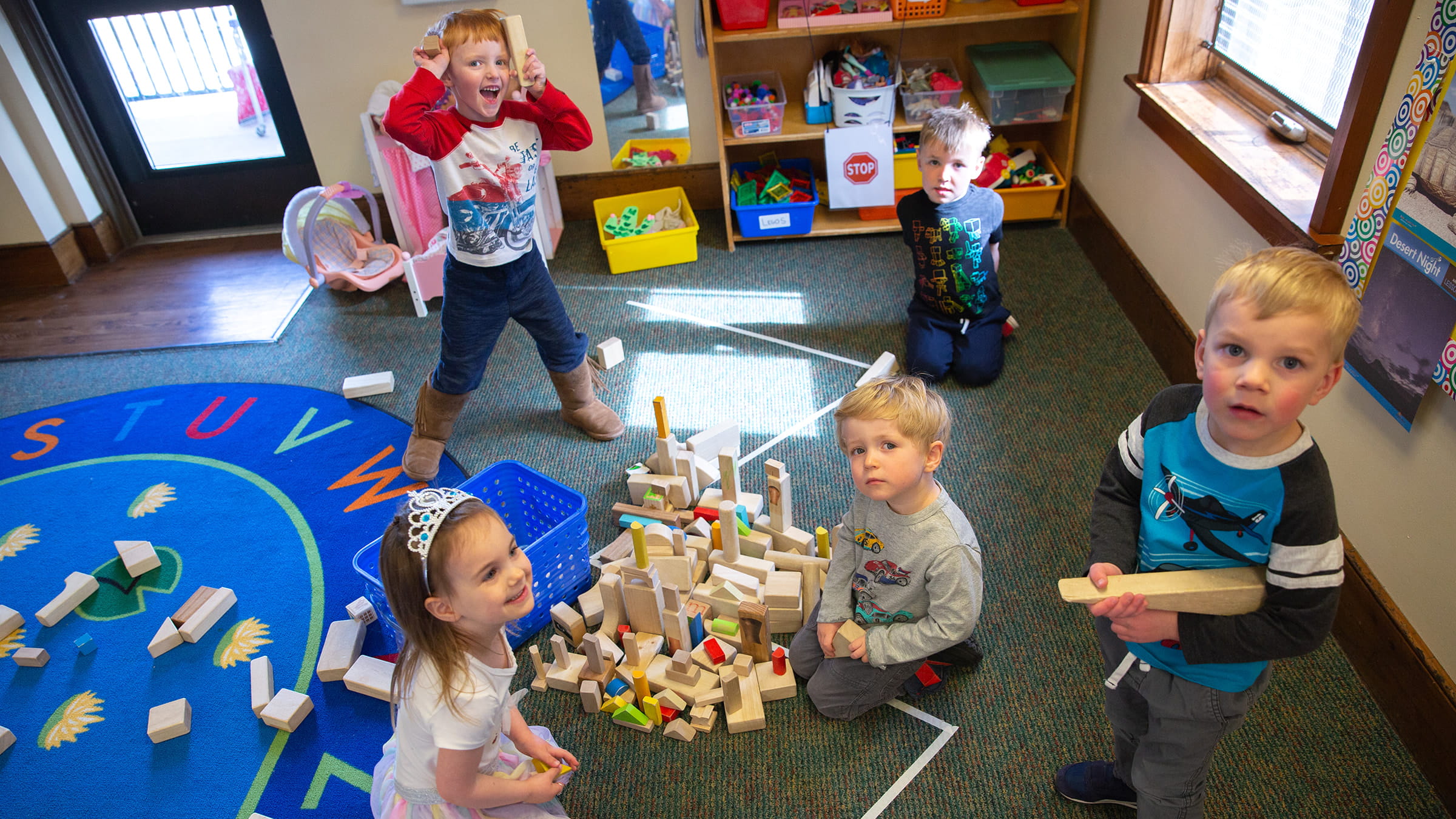 Kids playing in classroom together.