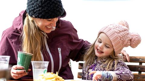 Mother and daughter eating a snack together.