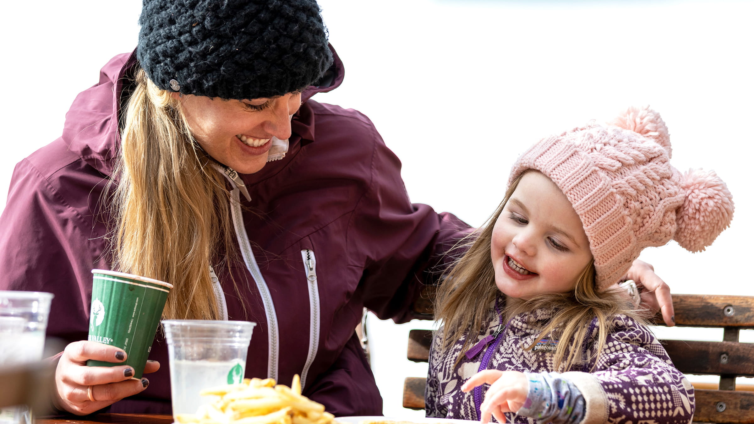 Mother and daughter eating a snack together.