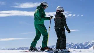Deer Valley instructor teaching young student to ski.
