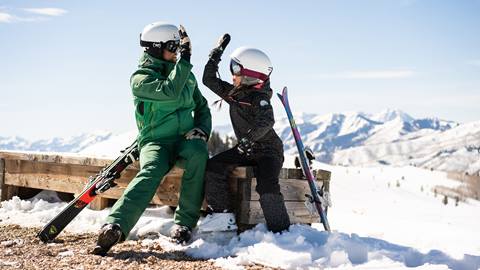 Ski instructor giving their student a high-five.