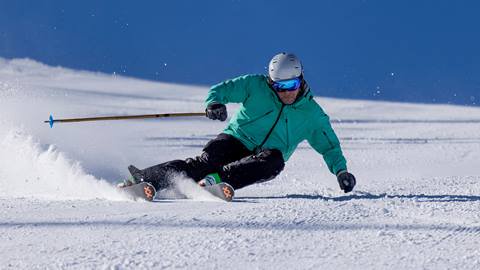 Deer Valley guest skiing groomed trail on bluebird day