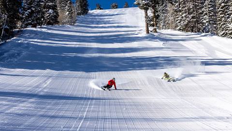 Two guests skiing groomed run at Deer Valley.