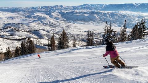 Person skiing behind another guest at Deer Valley Resort.