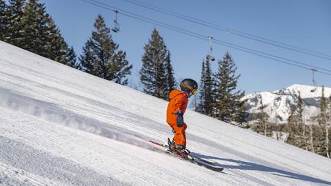 Boy skiing down groomed run at Deer Valley.