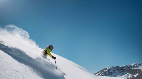 Skier on steep powder terrain at Deer Valley.