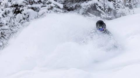 Skier skiing in deep powder at Deer Valley Resort.