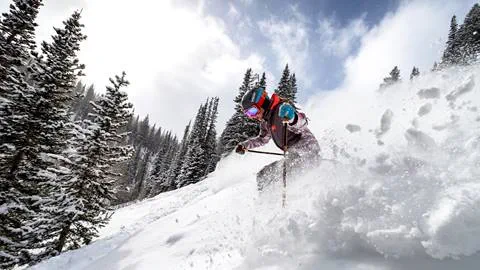 Woman skiing in deep powder at Deer Valley.