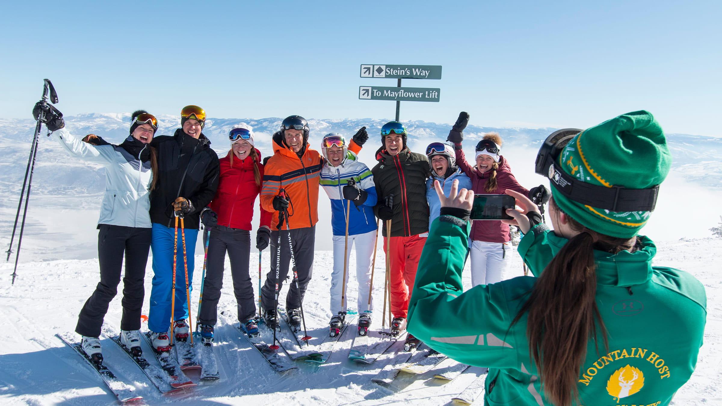 Mountain host giving tour to group of skiers