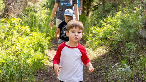 Young boy on nature hike while attending Deer Valley summer camp.