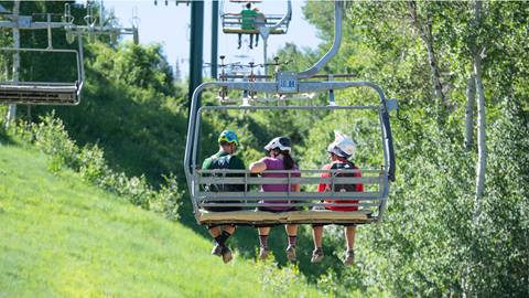Guests riding chairlift during summer at Deer Valley.